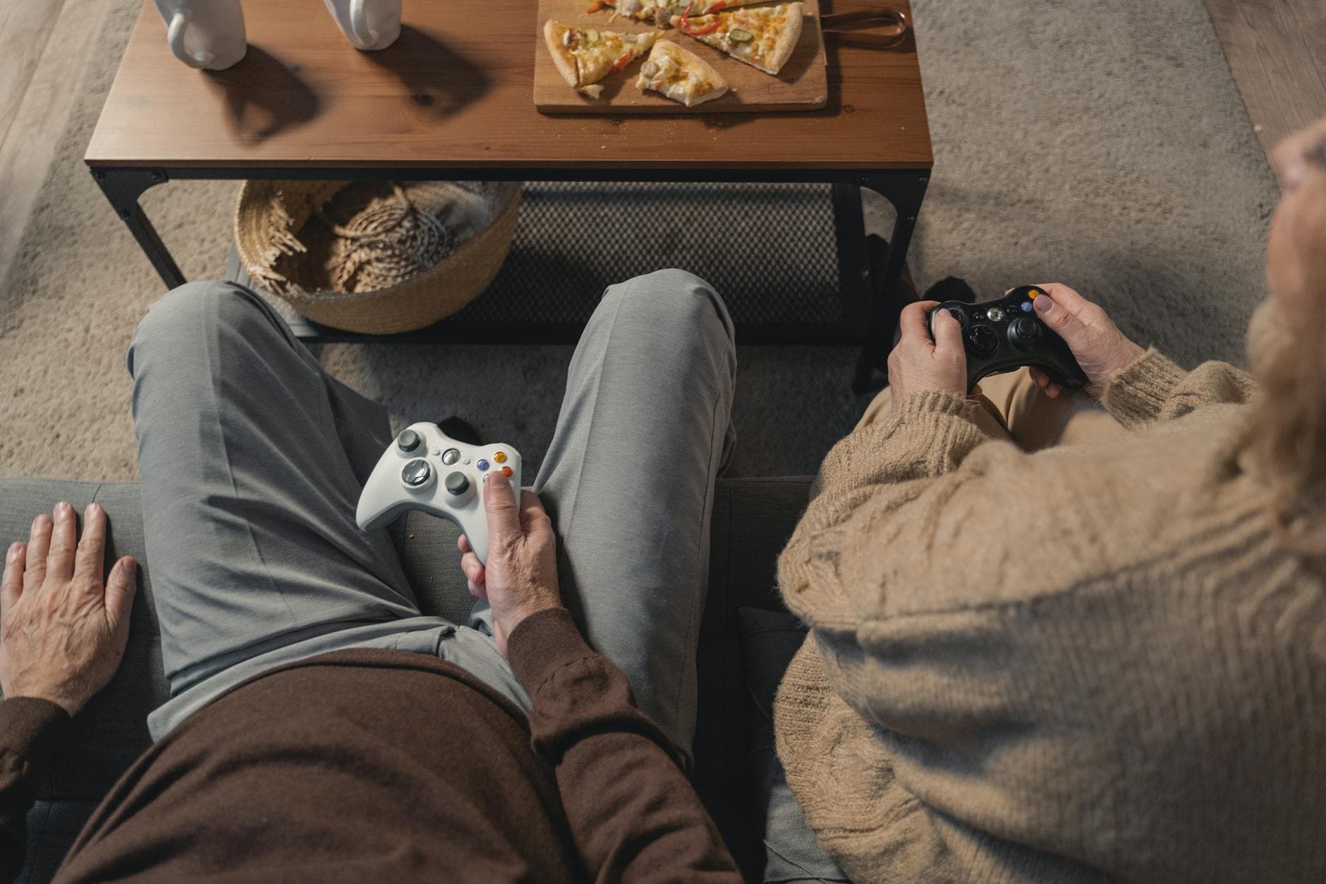 person in gray pants and brown pants sitting on brown couch