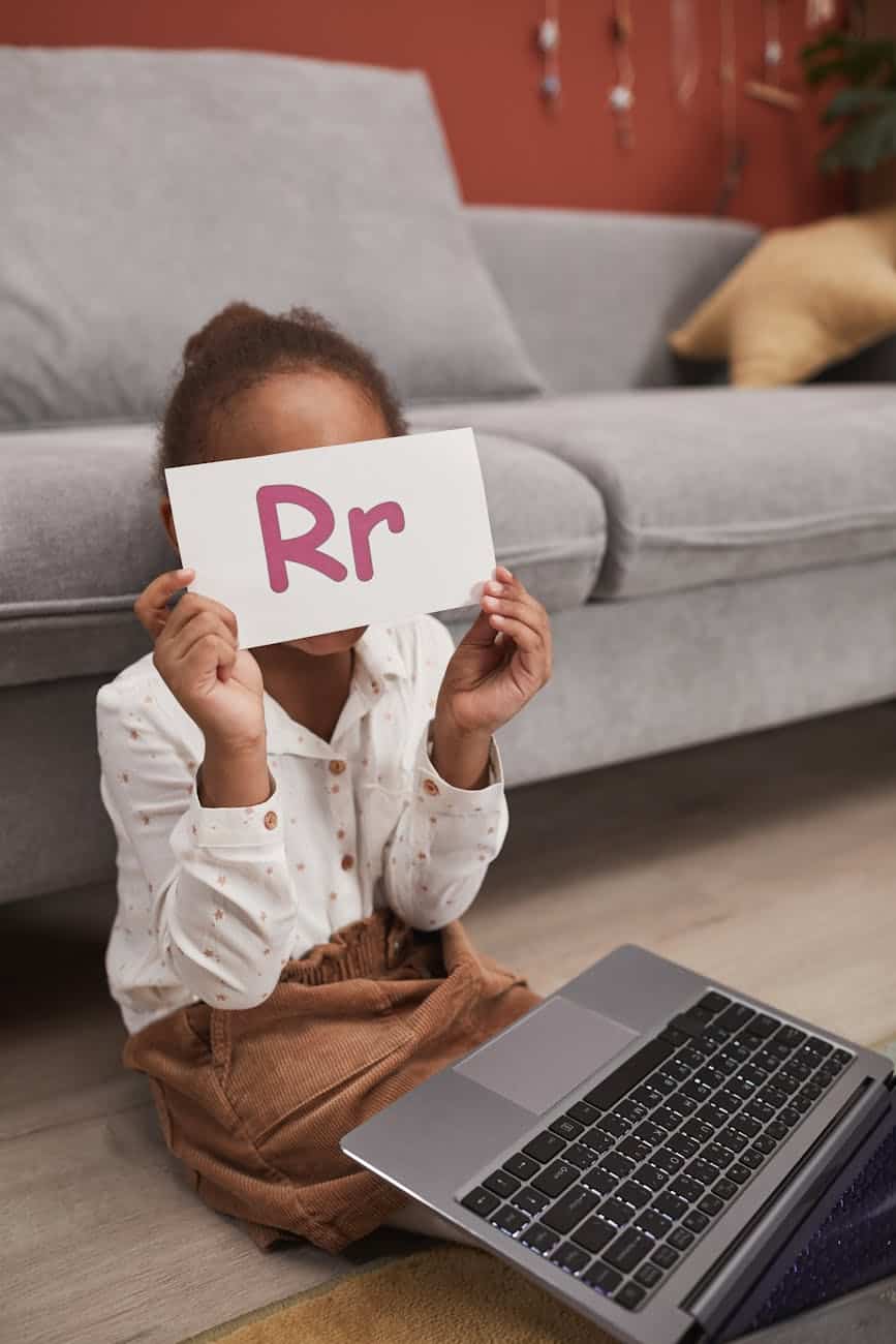 kid holding a flash card