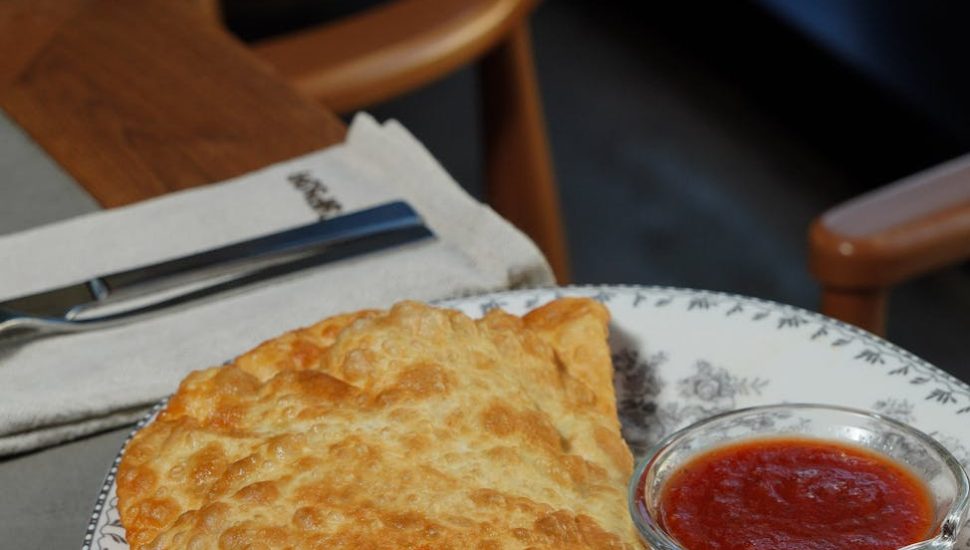 crispy fried empanada with tomato sauce