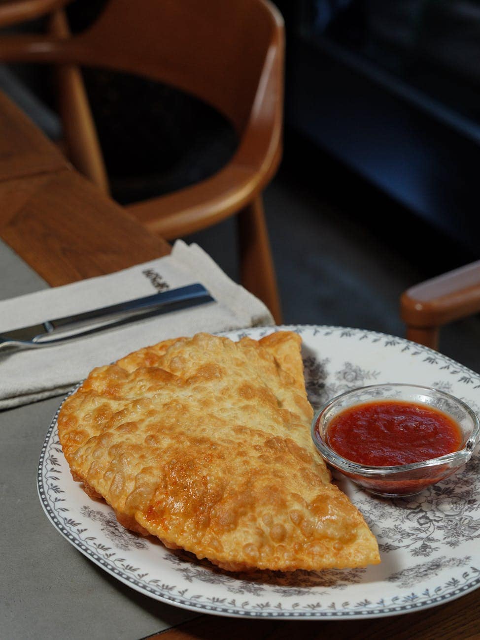 crispy fried empanada with tomato sauce