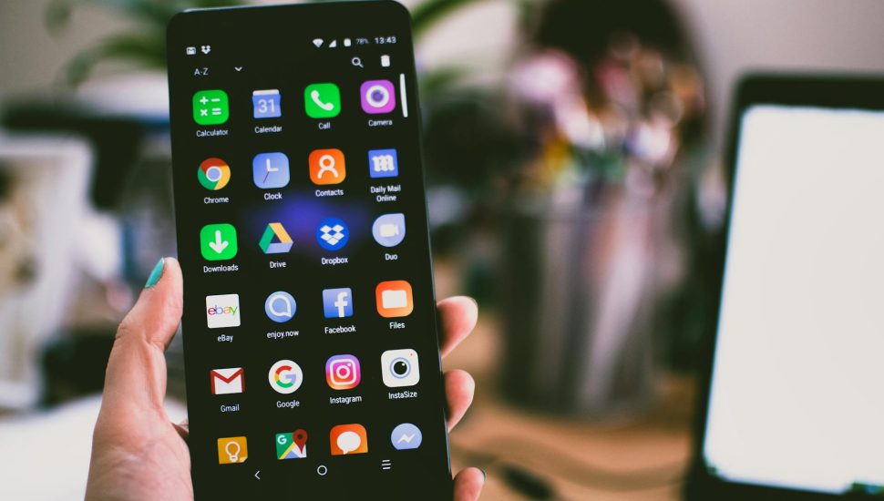 selective focus photography of person holding turned on smartphone