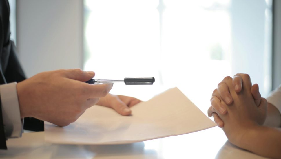 crop businessman giving contract to woman to sign
