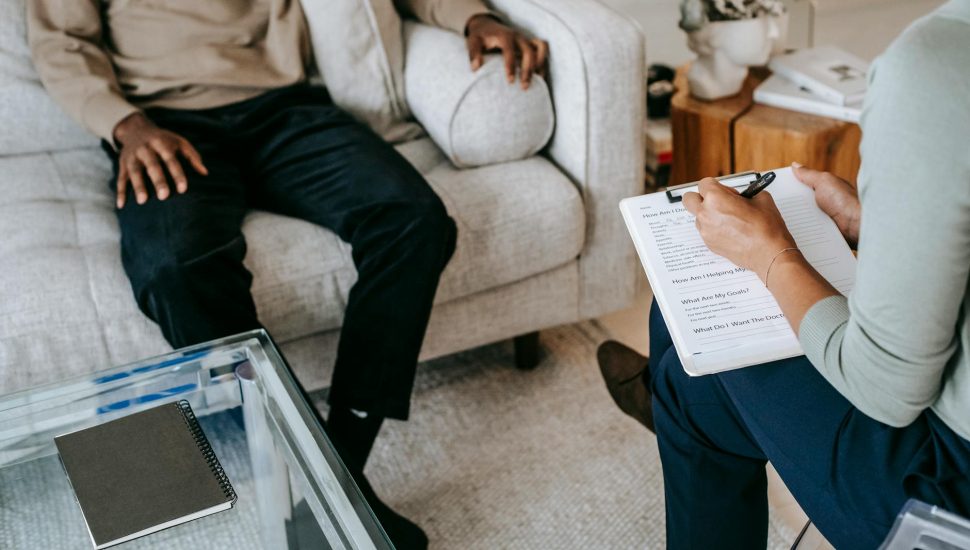 crop unrecognizable black man sharing complains with female psychologist