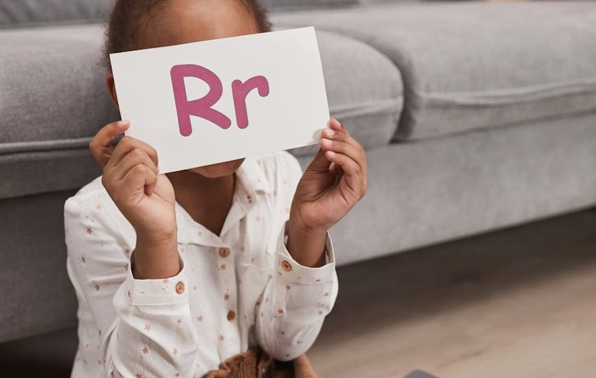 kid holding a flash card