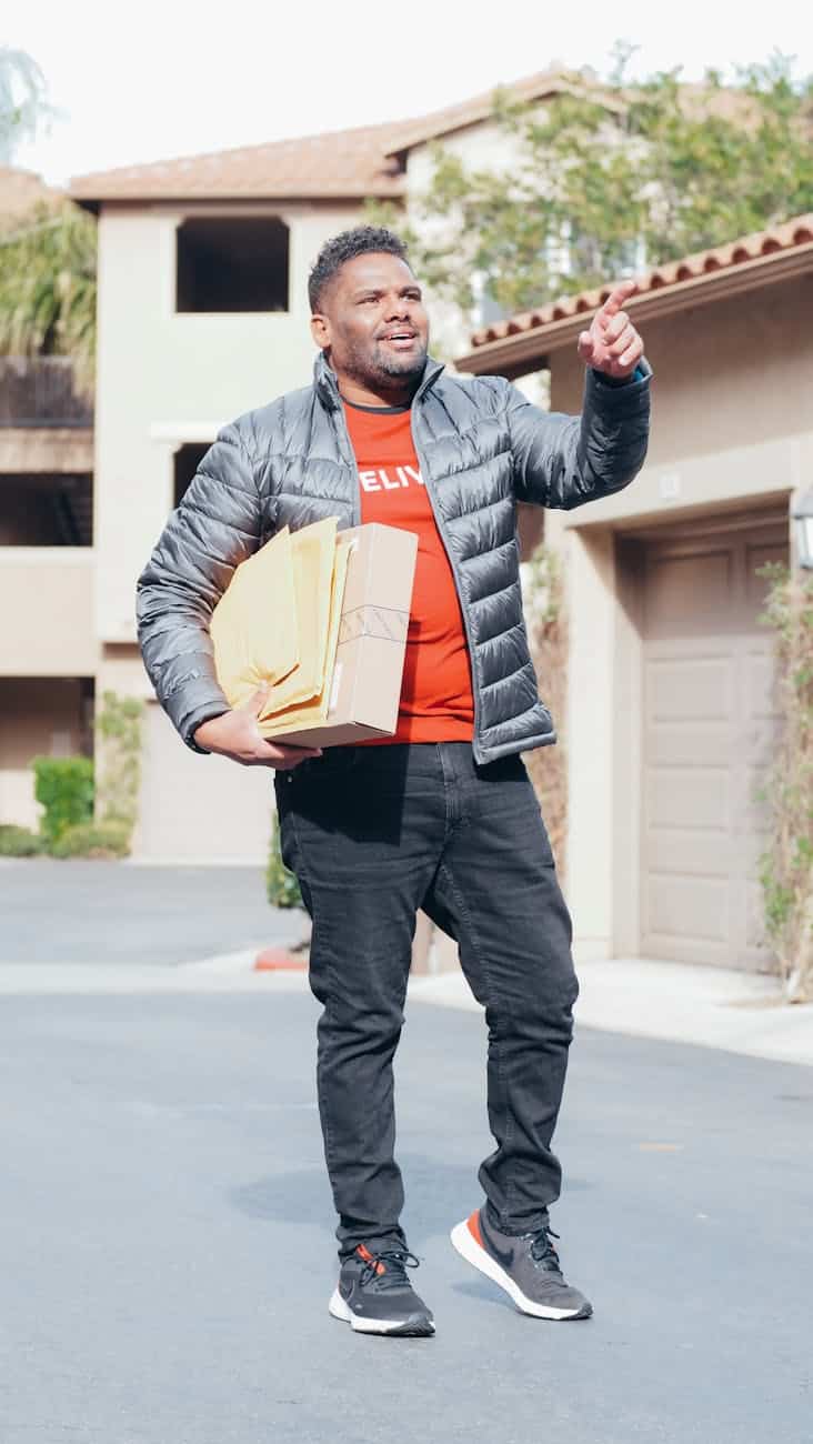 a man in gray jacket making a delivery