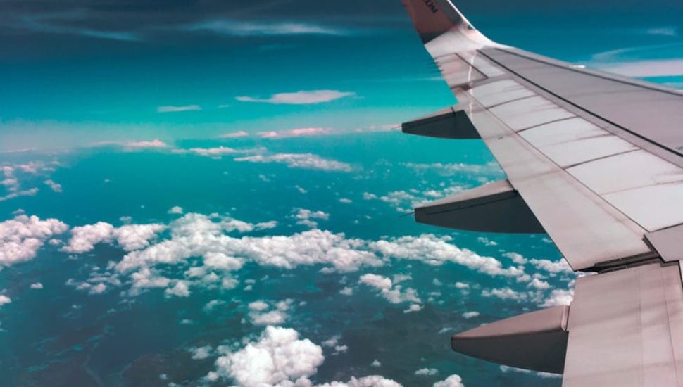 airplane wing above clouds