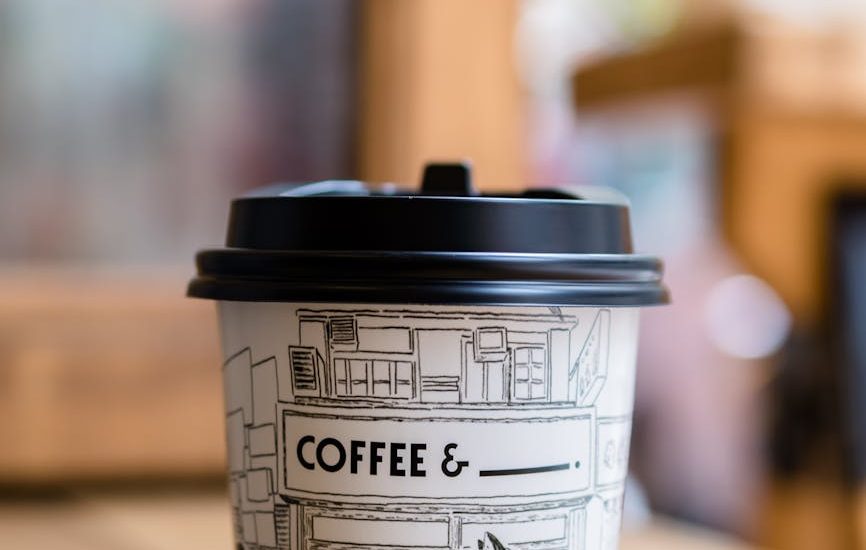 panda printed paper coffee cup on table