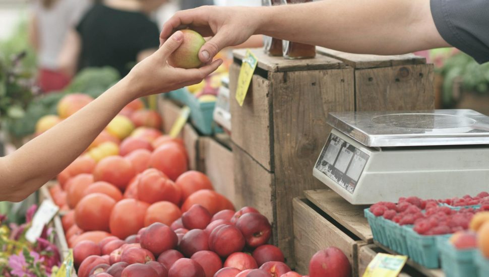 person giving fruit to another