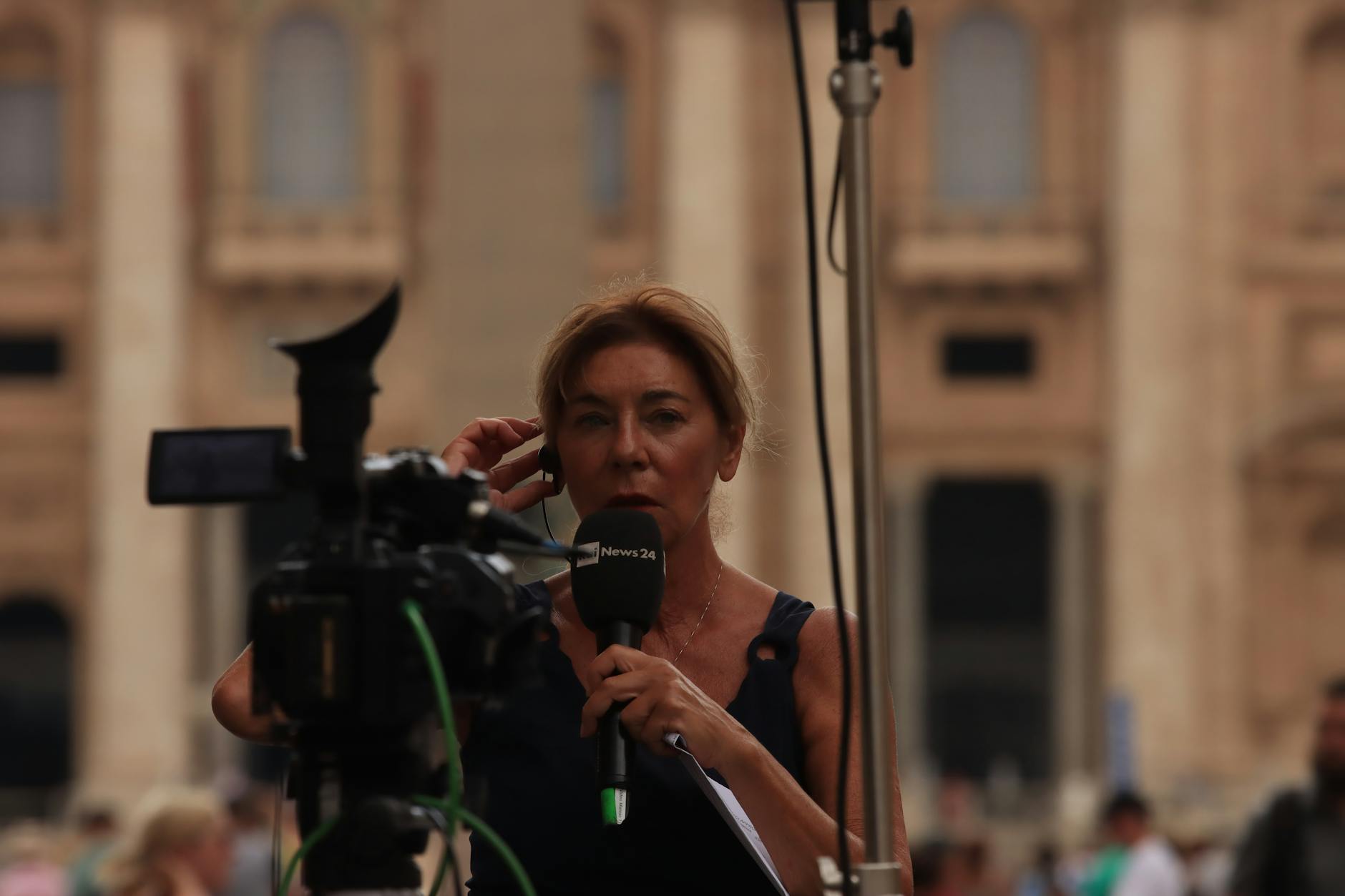 woman in red shirt holding black microphone
