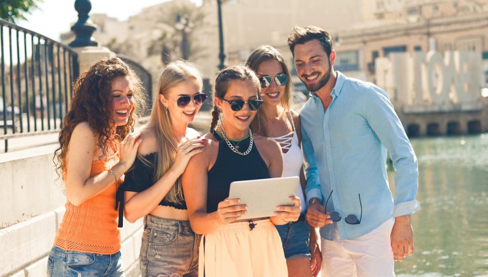 group of people standing beside body of water