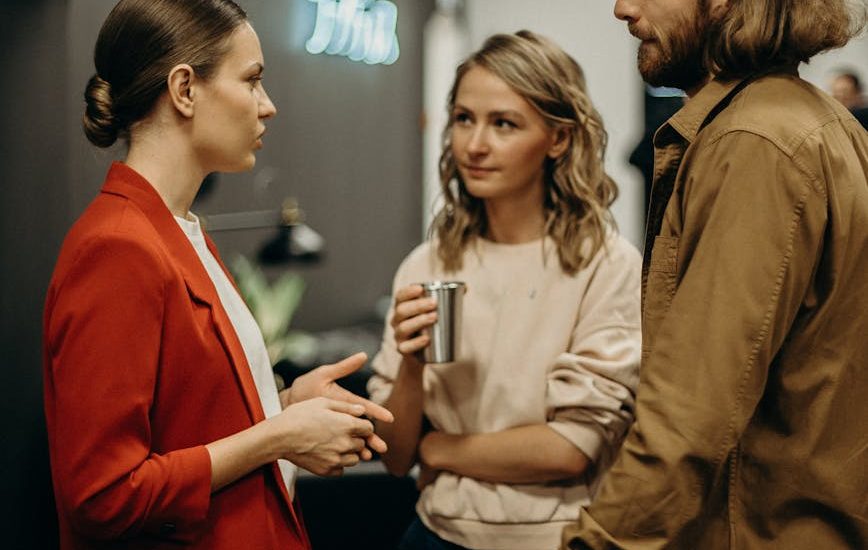 two women and man talking