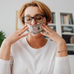 woman holding dollar against her face