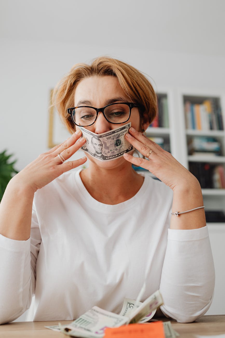 woman holding dollar against her face