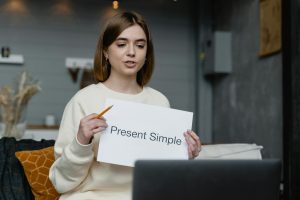 woman teaching in front of a laptop