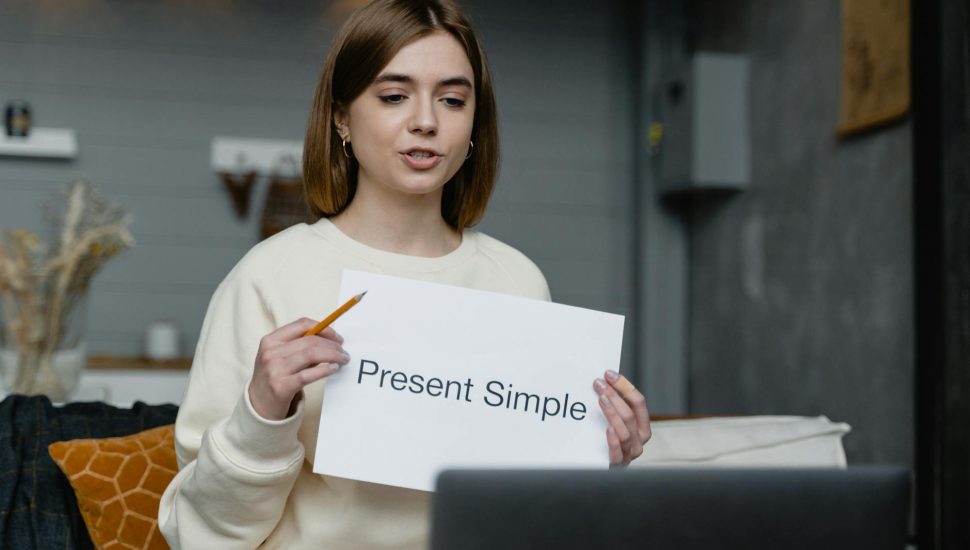 woman teaching in front of a laptop