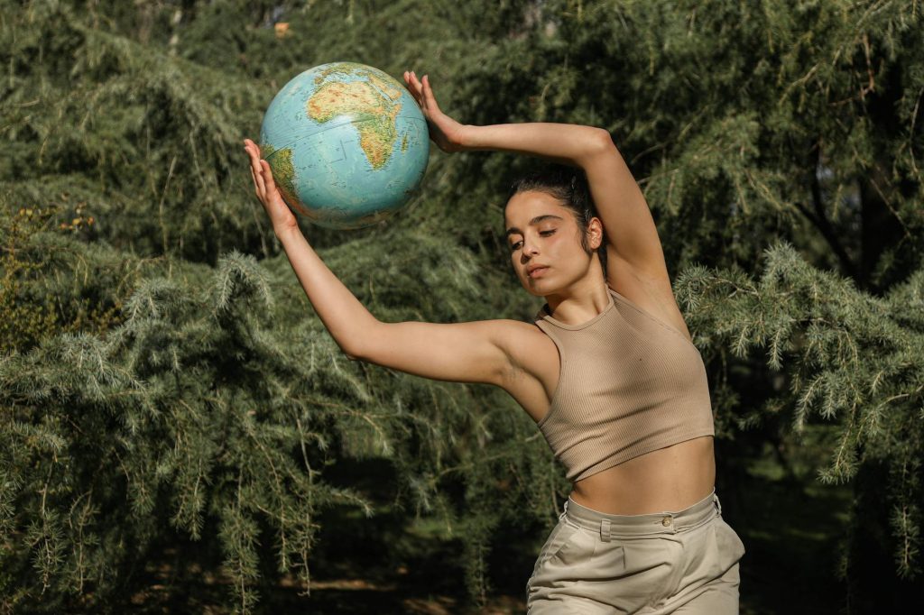 a young woman holding a globe