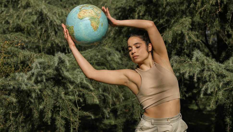 a young woman holding a globe