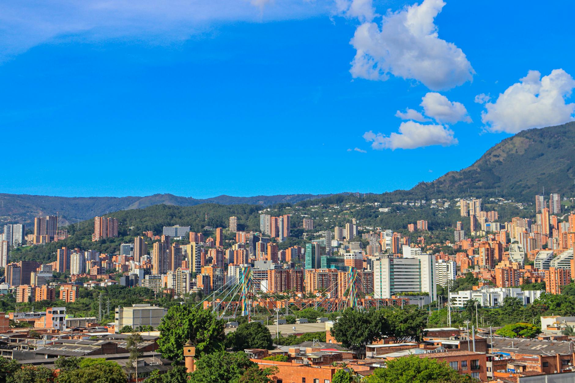 vibrant medellin cityscape under blue skies
