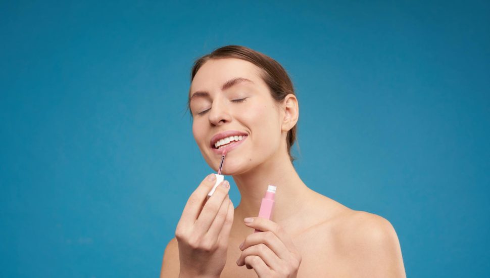 woman applying lipstick