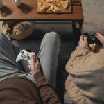 person in gray pants and brown pants sitting on brown couch
