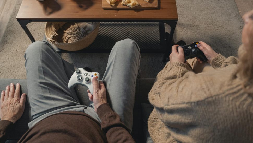 person in gray pants and brown pants sitting on brown couch